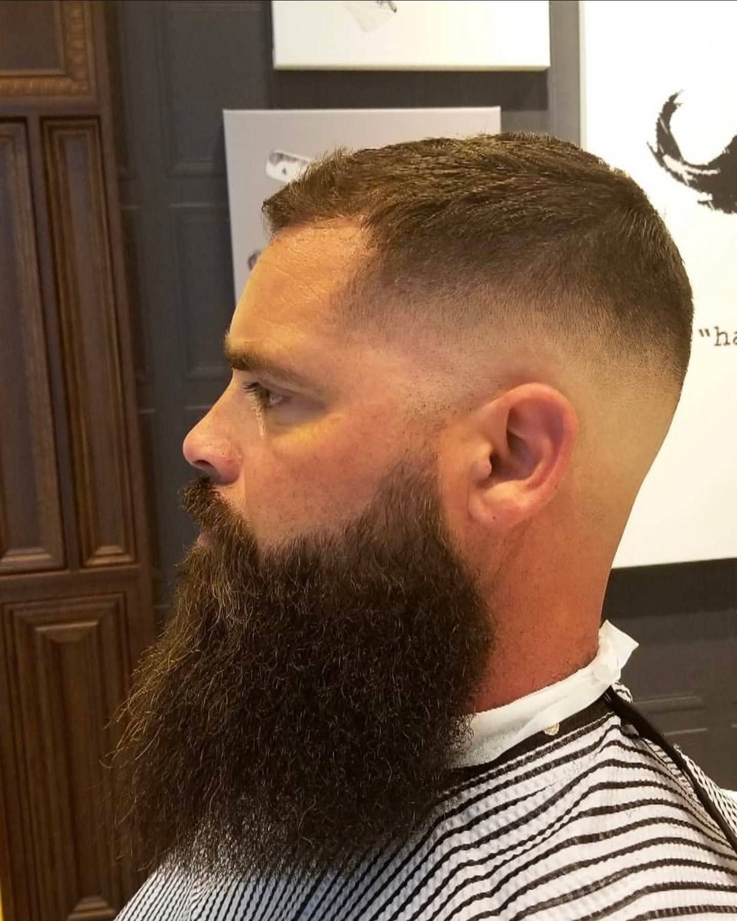 Full sculpted beard with a high skin fade