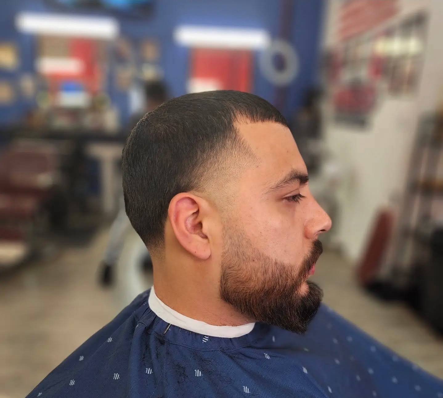 Clean fade with a shaped beard
