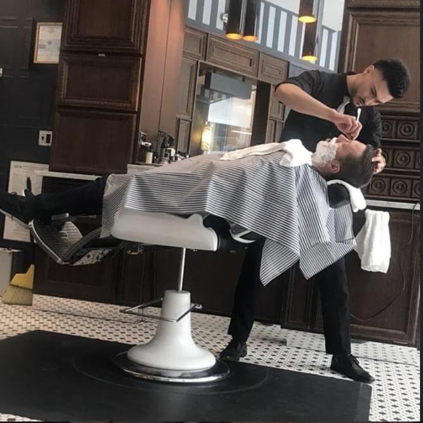 Juan giving a classic hot towel shave in the chair